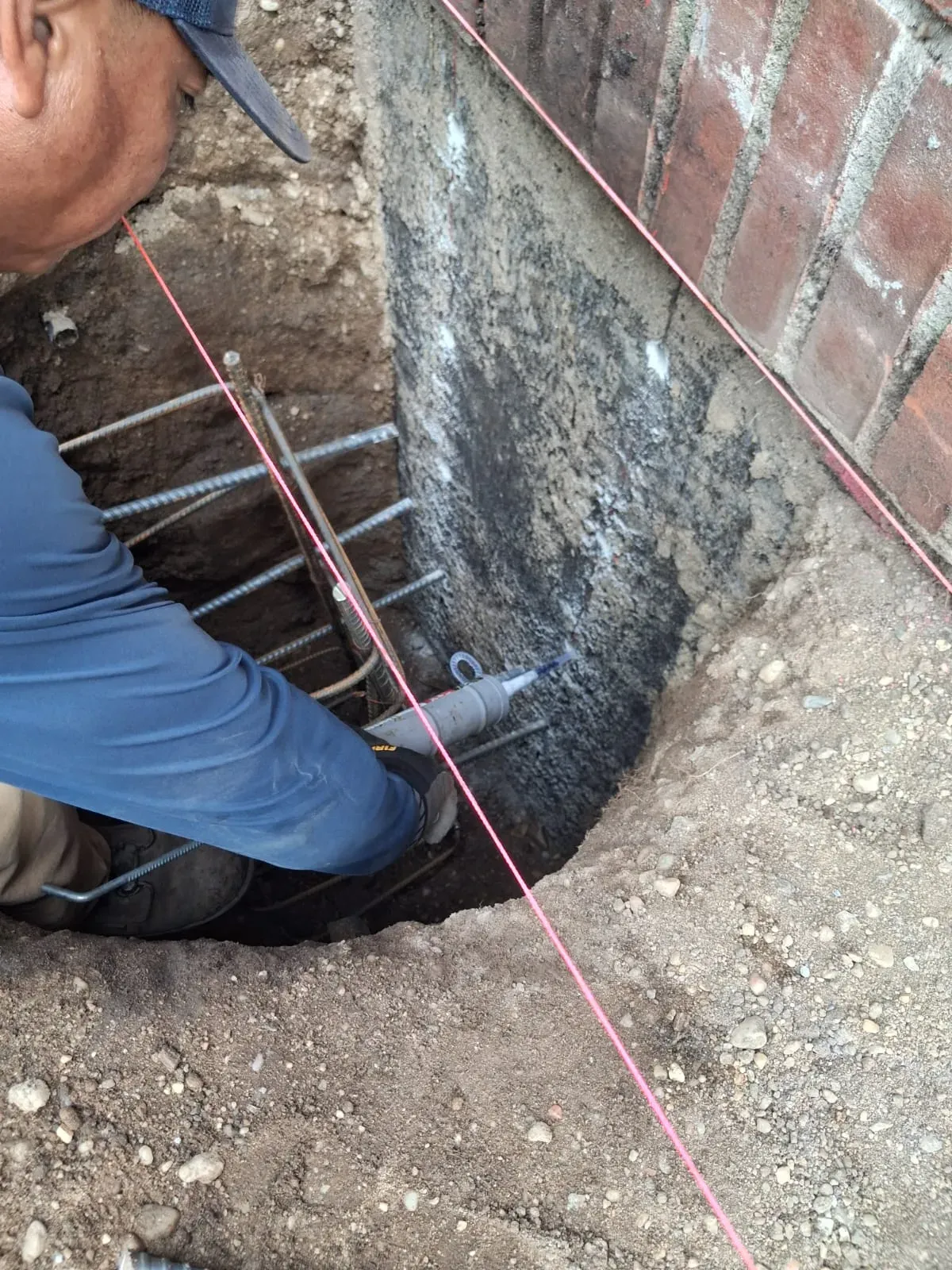Our crew working at a coated foundation wall in an excavation